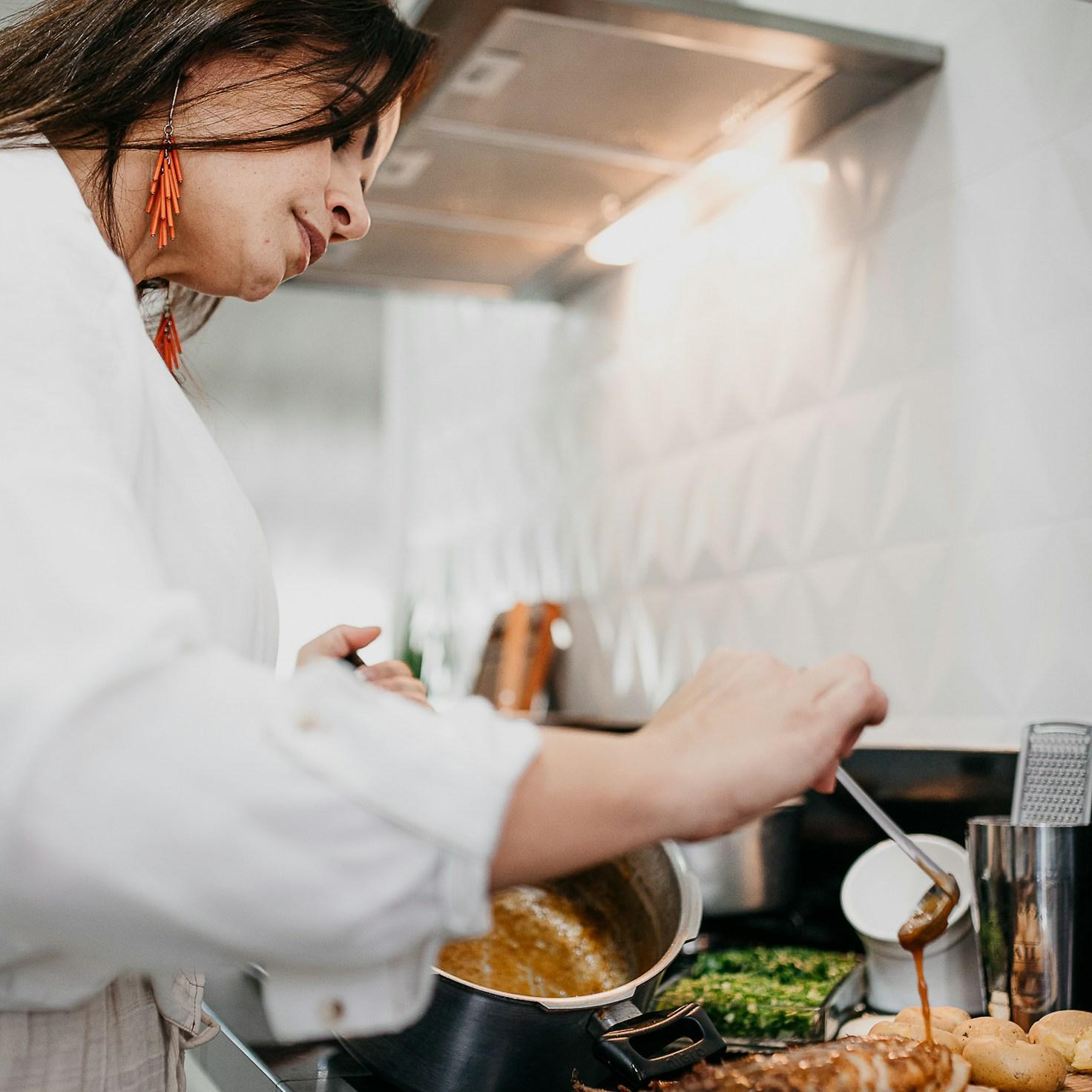 Community members collaborating in a modern kitchen space, sharing recipes and cooking techniques
